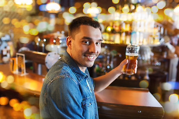 Image showing happy man drinking beer at bar or pub