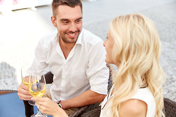 Image showing happy couple drinking wine at open-air restaurant