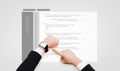 Image showing businessman hands with coding on smart watch
