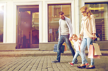 Image showing happy family with child and shopping bags in city