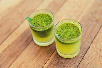 Image showing glasses of fresh juice or cocktail on beach