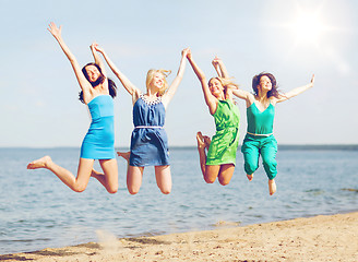 Image showing girls jumping on the beach