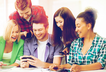 Image showing students looking at smartphone at school