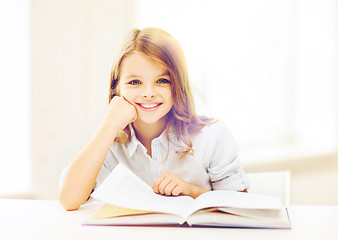 Image showing little student girl studying at school