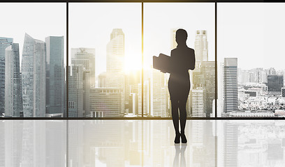 Image showing silhouette of business woman with folders