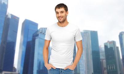 Image showing man in blank white t-shirt over singapore city