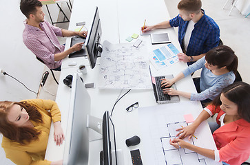 Image showing creative team with computers, blueprint at office