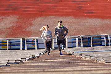 Image showing couple running upstairs on stadium