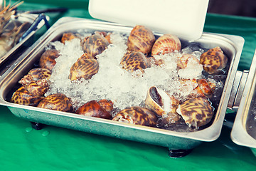 Image showing snails or seafood on ice at asian street market