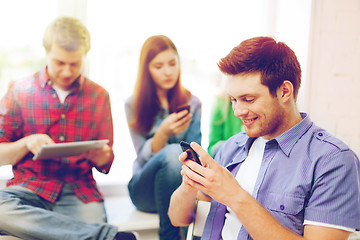 Image showing student looking into smartphone at school