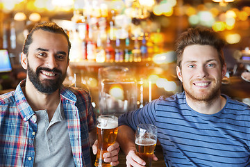 Image showing happy male friends drinking beer at bar or pub