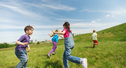 Image showing group of happy kids running outdoors