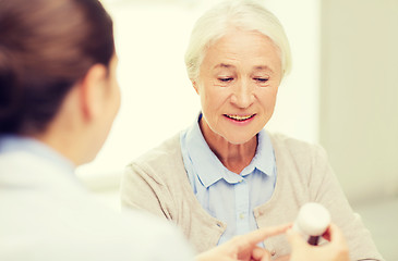 Image showing doctor with medicine and senior woman at hospital