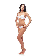 Image showing happy young woman in white bikini swimsuit