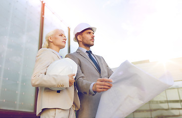 Image showing businessmen with blueprint and helmets