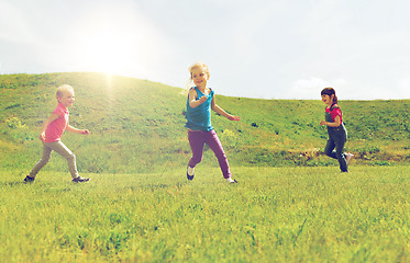 Image showing group of happy kids running outdoors