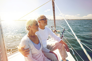 Image showing senior couple hugging on sail boat or yacht in sea