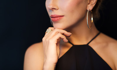 Image showing beautiful woman in black wearing diamond jewelry