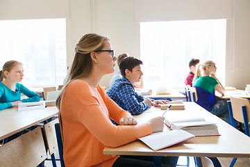 Image showing group of students with books at school lesson