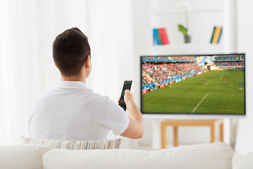 Image showing man watching football or soccer game on tv at home