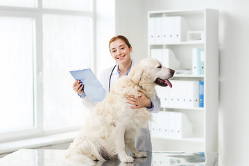 Image showing happy doctor with retriever dog at vet clinic