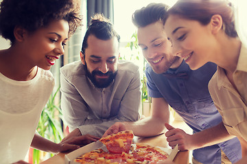 Image showing happy business team eating pizza in office