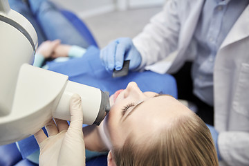 Image showing dentist and patient with dental x-ray machine