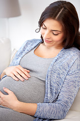 Image showing happy pregnant woman lying on sofa at home