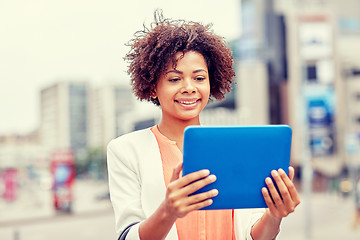Image showing happy african businesswoman with tablet pc in city