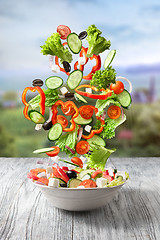 Image showing Fresh mixed vegetables falling into a bowl of salad