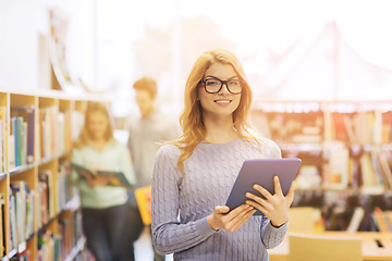 Image showing happy student girl with tablet pc in library