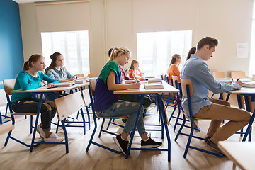 Image showing group of students with books writing school test