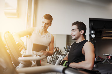 Image showing men exercising on gym machine