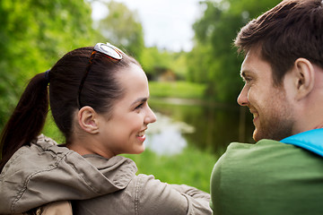 Image showing smiling couple with backpacks in nature