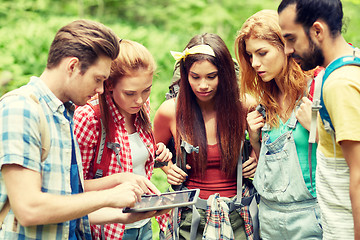 Image showing friends with backpacks and tablet pc hiking