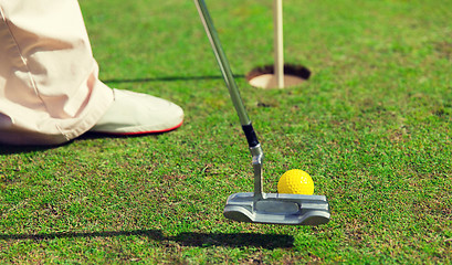 Image showing close up of man with club and ball playing golf