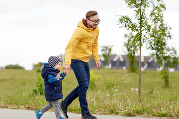 Image showing happy father and little son walking outdoors