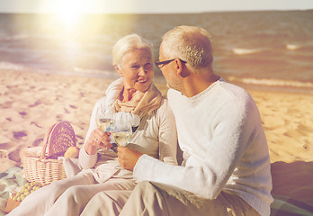 Image showing happy senior couple talking on summer beach