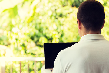 Image showing close up of businessman with laptop outdoors