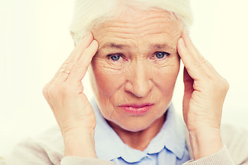 Image showing face of senior woman suffering from headache