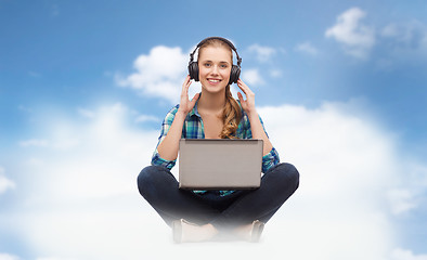 Image showing woman with laptop computer and headphones