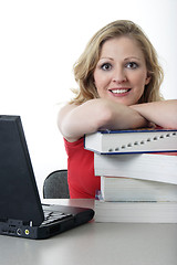 Image showing Happy girl leaning on textbooks