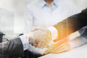 Image showing two businessmen shaking hands in office