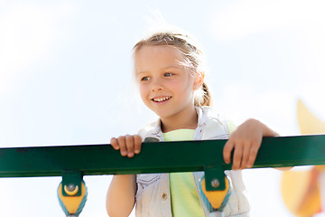 Image showing happy little girl climbing on children playground