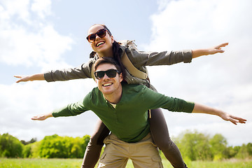 Image showing happy couple with backpacks having fun outdoors