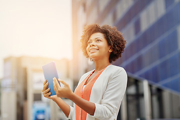 Image showing happy african businesswoman with tablet pc in city