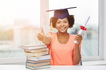 Image showing happy african bachelor girl with books and diploma