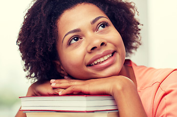 Image showing happy african student girl with books at home