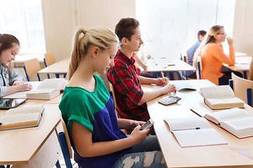 Image showing student girl with smartphone texting at school