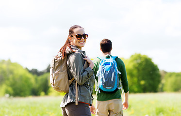 Image showing happy couple with backpacks hiking outdoors